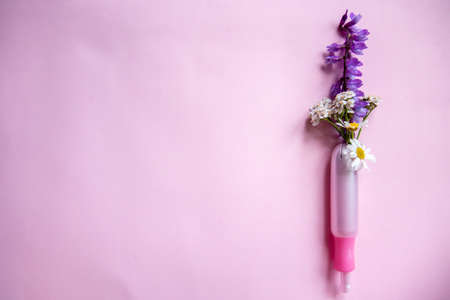 Menstrual tampons and chamomile on pink background.の写真素材