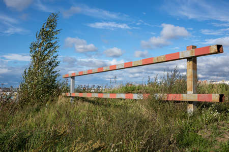 Old barrier overgrown with grass outside the cityの写真素材