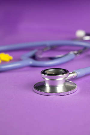 Stethosop on a purple background with yellow capsulesの写真素材