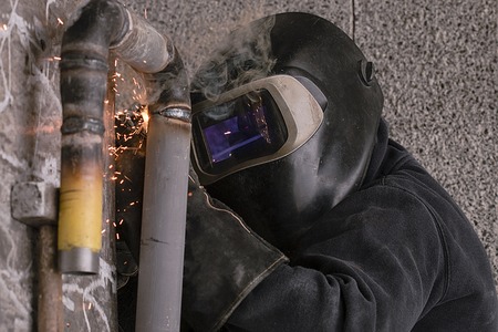 the welder welds pipes for gas installation