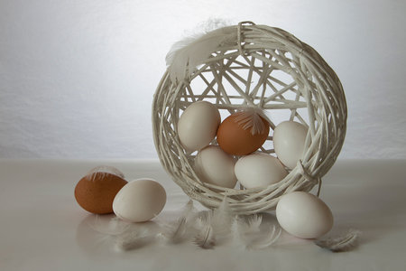 The white Easter eggs with feathers