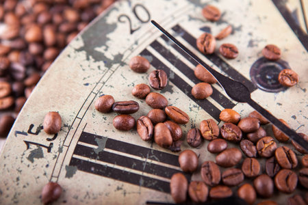 vintage clock and coffee beans scatteredの写真素材