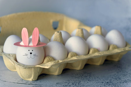 funny egg with bunny ears in trayの写真素材