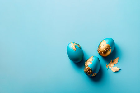 Three easter eggs decorated with gold on blue backgroundの写真素材