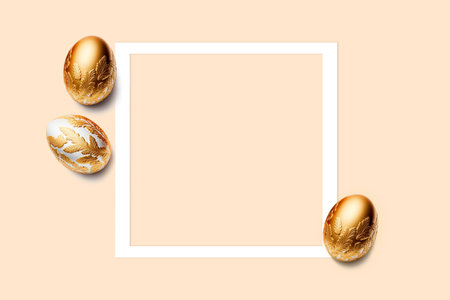 Frame and three easter eggs decorated with gold on pink background. Flat lay, top view, copy space.の写真素材