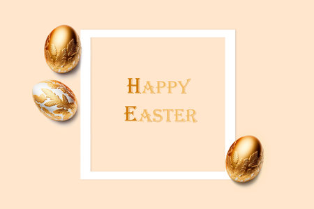 Frame and three easter eggs decorated with gold on pink background. Happy Easter title. Flat lay, top view, copy space.の写真素材