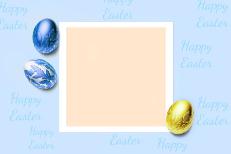 Frame and three easter eggs colored blue and golden yellow. Happy Easter card with copy space for text. Minimal style.の写真素材