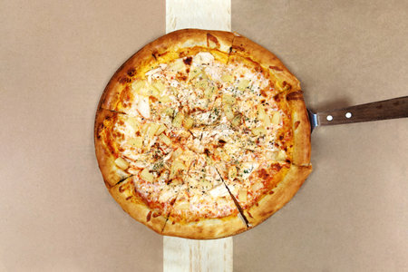Delicious hot tasty Hawaiian Pizza with chicken fille and pineapple. Top view.の写真素材