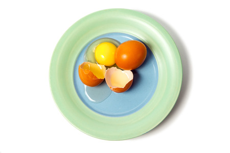 Cracked egg on the plateの写真素材