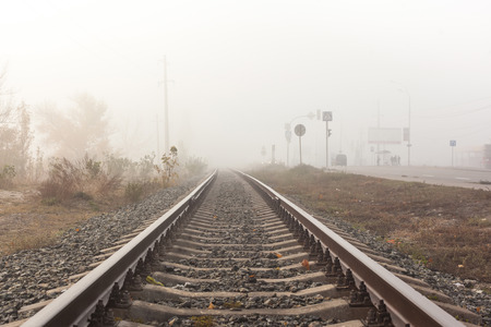 Old railway track at foggy weather morning