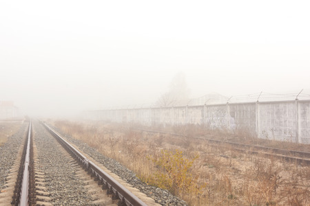 Old railway track at foggy weather morning