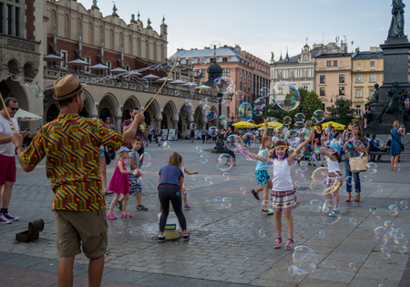 Krakow, Poland - July 2017: People blow bubbles on market squareのeditorial素材