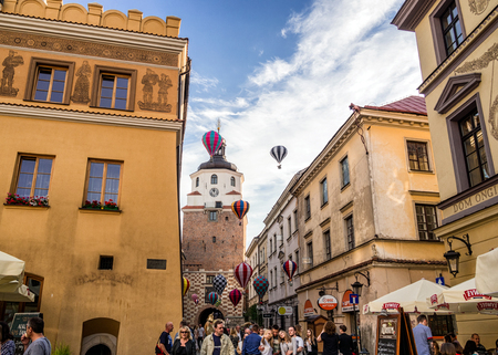 Lublin, Poland - July, 2017: Beautiful street, flying balloons and old buildings in the old town. Brama street, Lublin. Mountebanks Carnaval in Lublin.のeditorial素材
