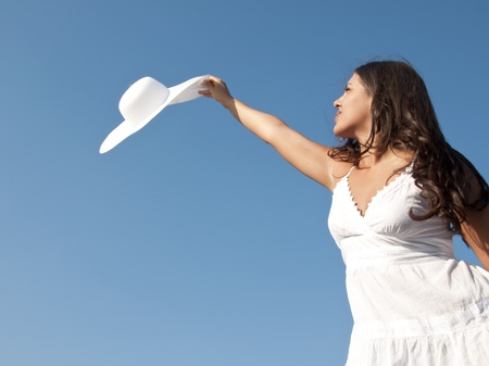 girl in sky with hatの写真素材