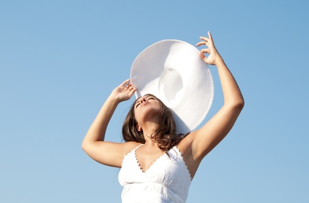 girl in sky with hatの写真素材