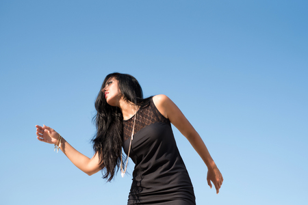 Fashion woman on sky backgroundの写真素材