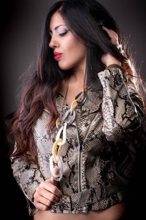 High Fashion model woman in lights posing in studio, portrait of beautiful sexy girl with trendy...
