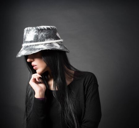 Elegant woman in hat are thinkingの写真素材