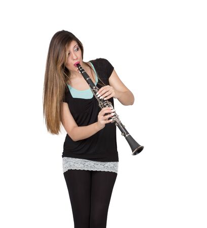 beautiful woman play clarinet on withe backgroundの写真素材