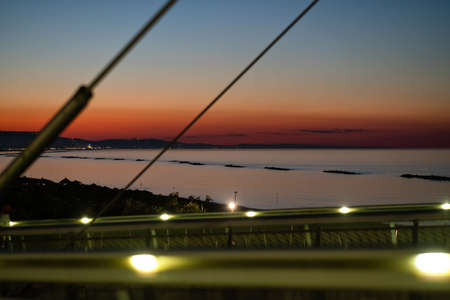 beautiful sun set on the sea from pescara city bridge called ponte del mare in Italyの写真素材