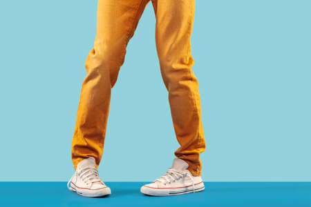 Cropped shot of footwear on blue studio backgroundの写真素材