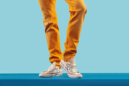 Cropped shot of white footwear on blue studio backgroundの写真素材