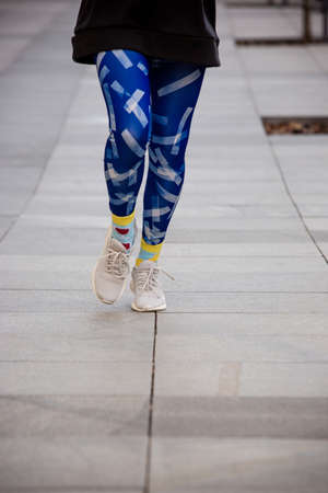Young sport woman in bright sportswear doing morning running outdoors.の写真素材