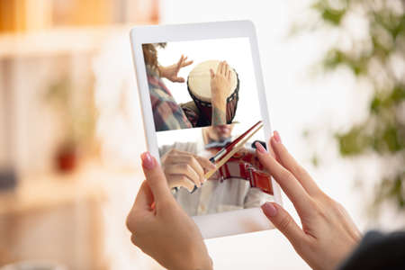 Close-up female hands with digital tablet. Online learning concept.