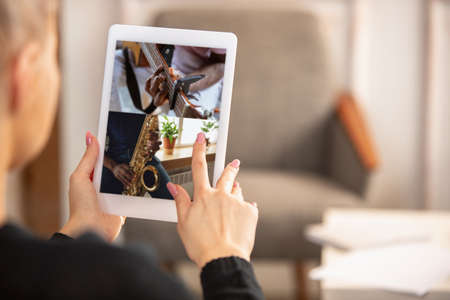 Close-up female hands with digital tablet. Online learning concept.