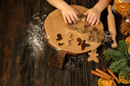 Close-up kids hands making festive decorations, cookies homemade gingerbread.の写真素材