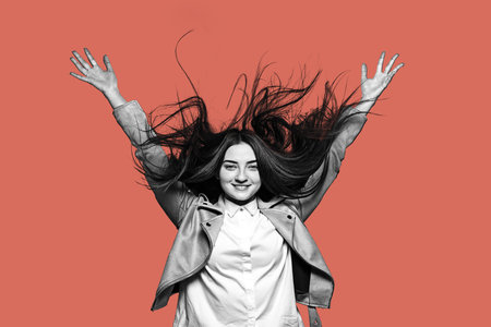 Portrait of young happy girl isolated on red background. Human emotions concept.