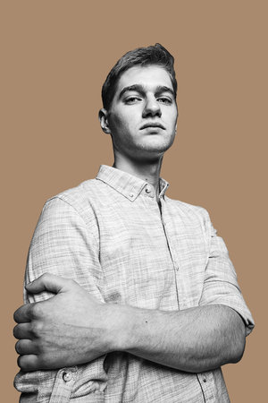 Half-length portrait of young man isolated over pastel color background.の写真素材