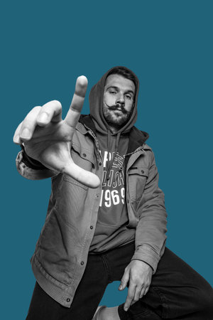 Portrait of young man isolated over blue background. Human emotions.の写真素材