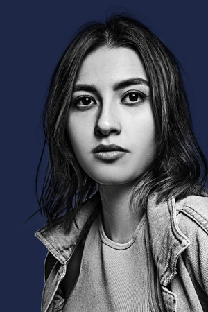 Close-up portrait of young beautiful girl isolated on blue background.