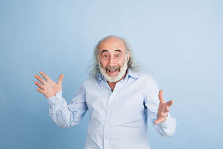 Half-length portarit of senior grey-haired man isolated over light background.