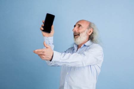 Half-length portarit of senior grey-haired man isolated over light background.
