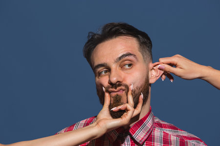 Half-length portrait of young Caucasian man isolated over blue background.の写真素材