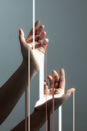 Light rays passing through human hands isolated on light grey background.