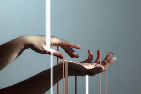 Light rays passing through human hands isolated on light grey background.