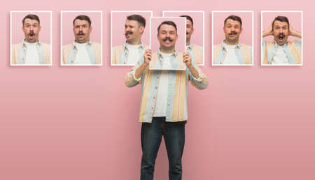 Young man showing portraits with different emotions isolated on pink background.