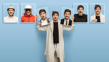 Young man showing portraits with different emotions isolated on blue background.の写真素材