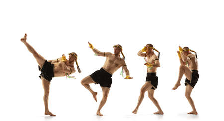 Young man thai boxer on white background in motion of step to step leg kicking.の写真素材