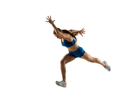 Beautiful woman, track athlete training isolated over white studio background.の写真素材