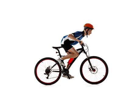 Young Caucasian boy bike rider with road bike isolated over white background.の写真素材