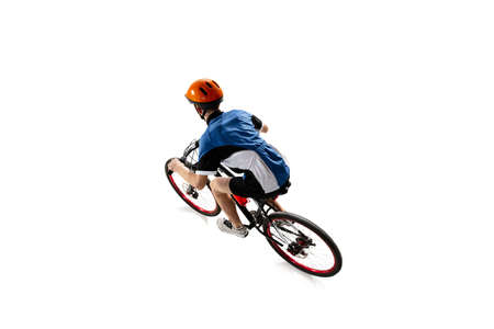 Young Caucasian boy bike rider on road bike isolated over white background.の写真素材