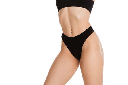 Beautiful female body in black underwear over white background.の写真素材