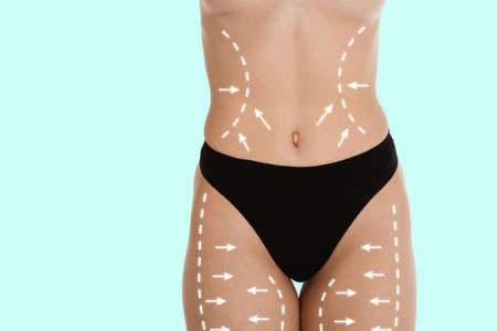 Cropped slim female body in white underwear isolated over light background.