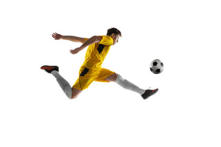 Young man, male soccer football player training isolated on white background.の写真素材