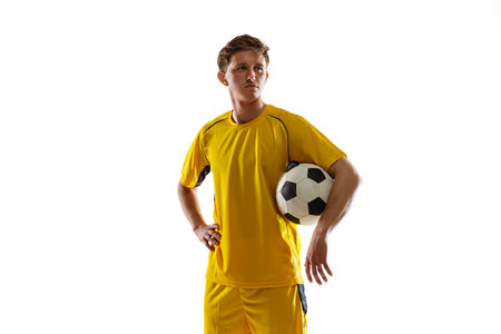Portrait of young soccer football player posing isolated on white background.の写真素材