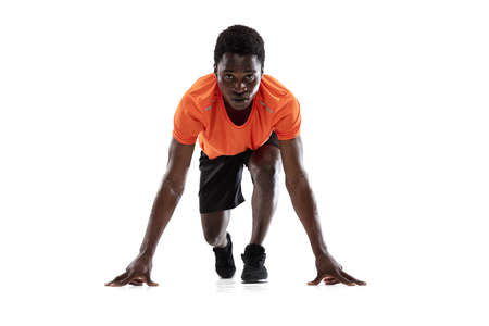 Portrait of young African-American man, athlete isolated over white background.